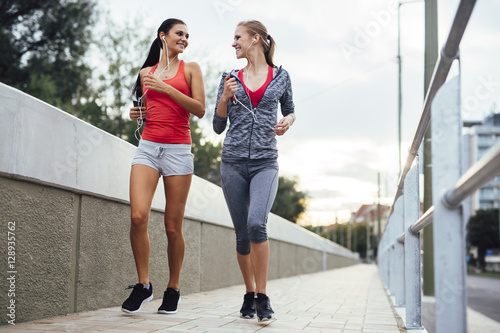 Women jogging in city in dusk