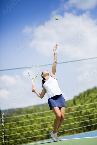 Beautiful female tennis player serving © NDABCREATIVITY