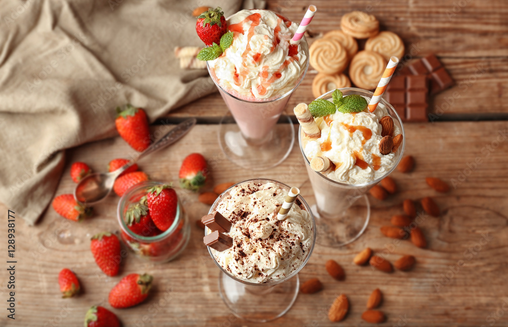 Delicious milkshakes on wooden background Delicious milkshakes on wooden background