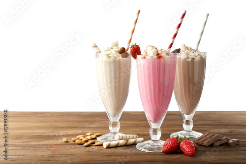 Delicious milkshakes on white background