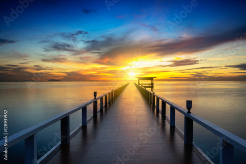 Wooden bridge at the sea at sunset