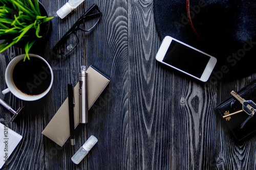 electronic cigarettes and mens accessories on wooden background top view