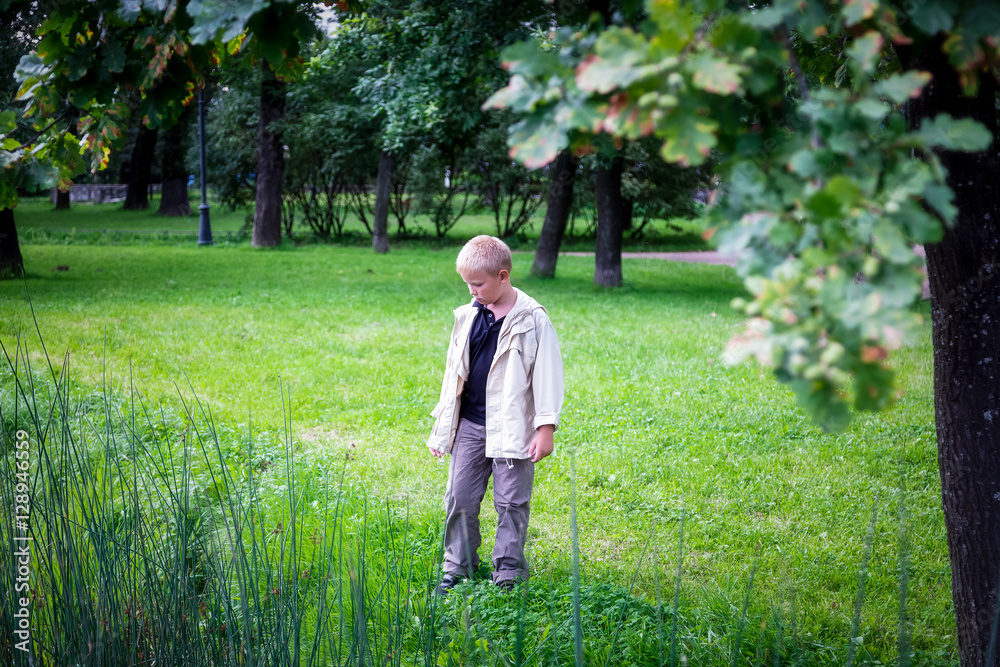 Boy walks in a city Park Boy walks in a city Park