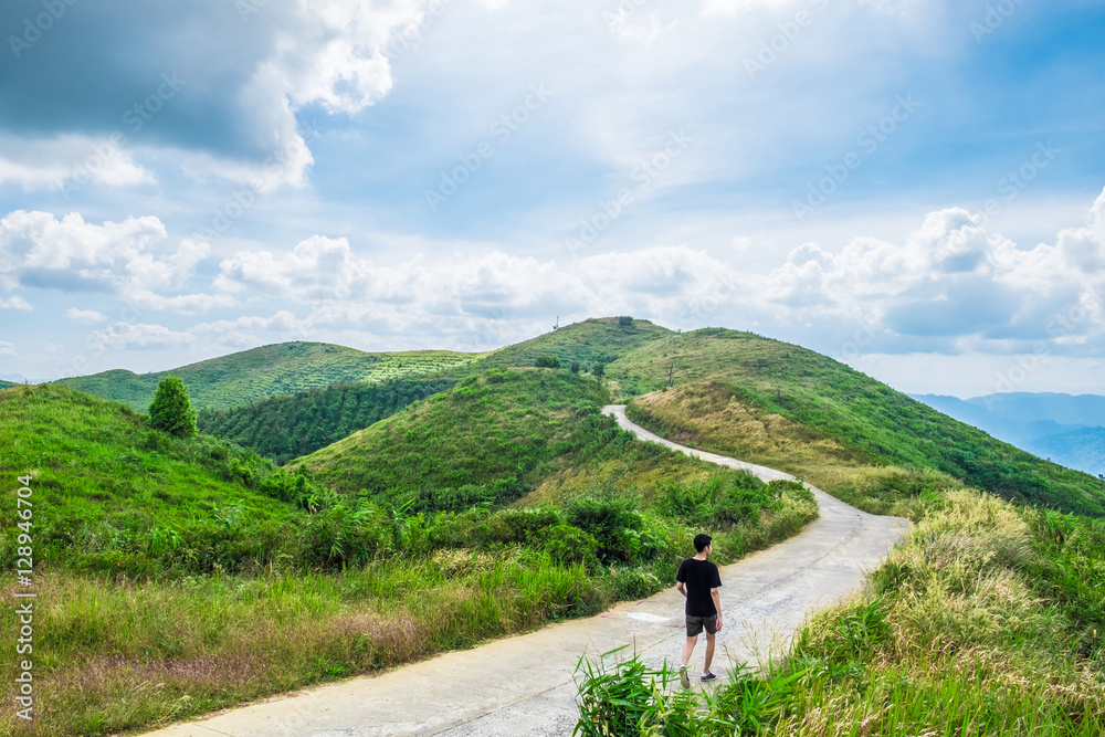 Man walking road way curve on mountain