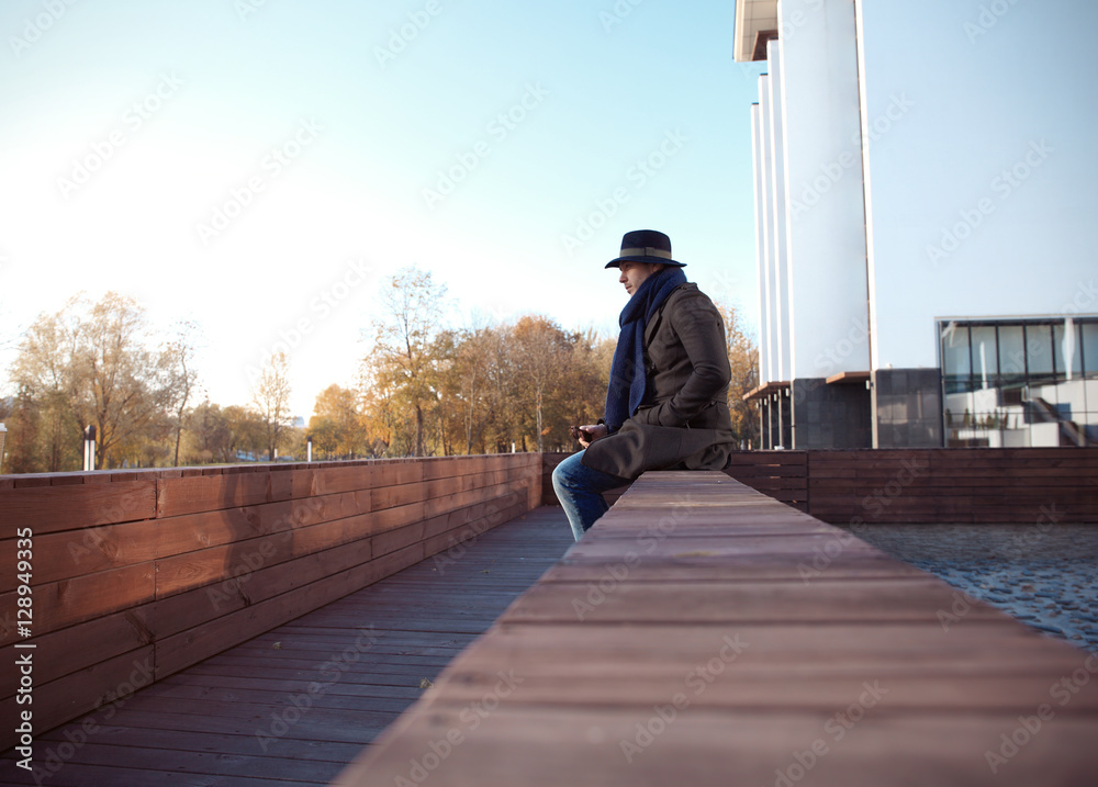 Trendy handsome young man in autumn fashion standing in urban environment. Trendy handsome young man in autumn fashion standing in urban environment.