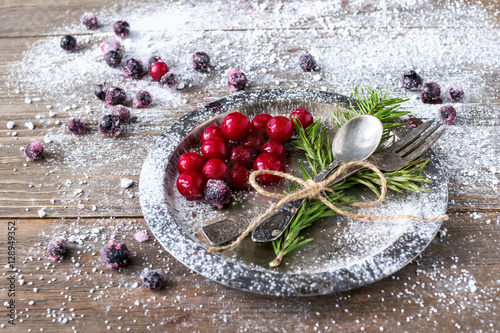 Fototapeta Naklejka Na Ścianę i Meble -   Ripe red cherry embellished with powdered sugar and a sprig of