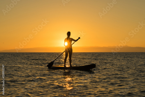 woman on paddle board sunset © Dmitry_Evs