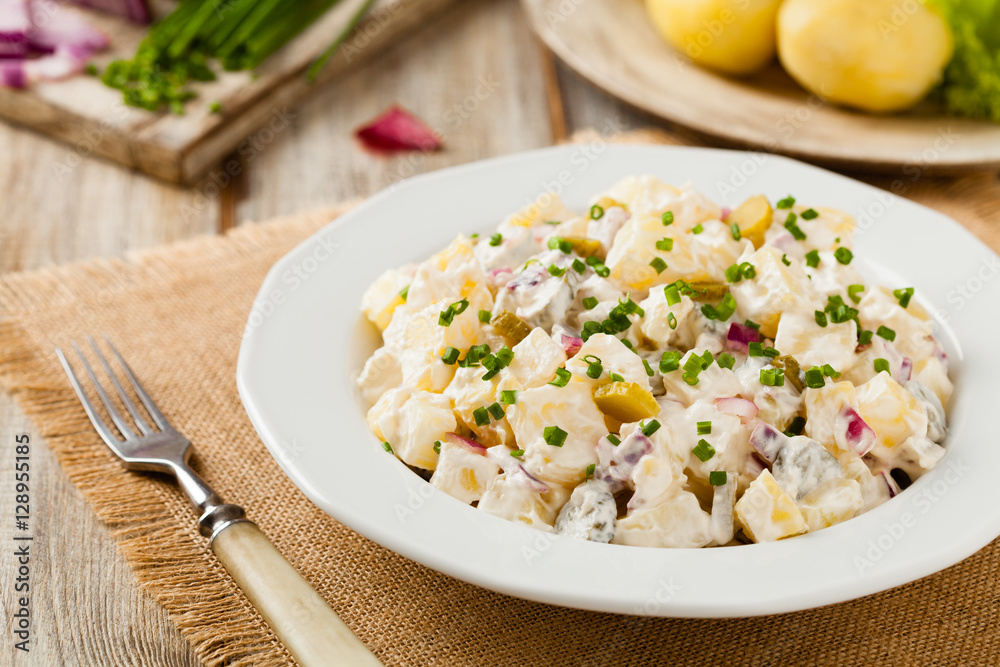 Traditional German potato salad with cucumber, onion and mayonna Traditional German potato salad with cucumber, onion and mayonna