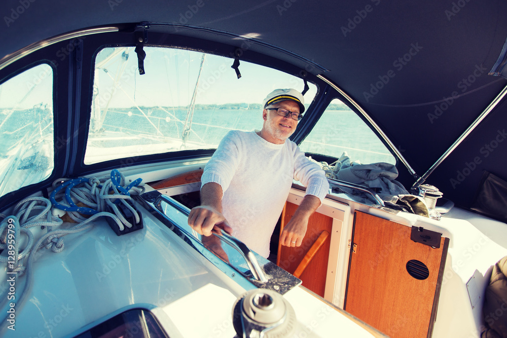 Naklejka premium happy senior man on boat or yacht sailing in sea