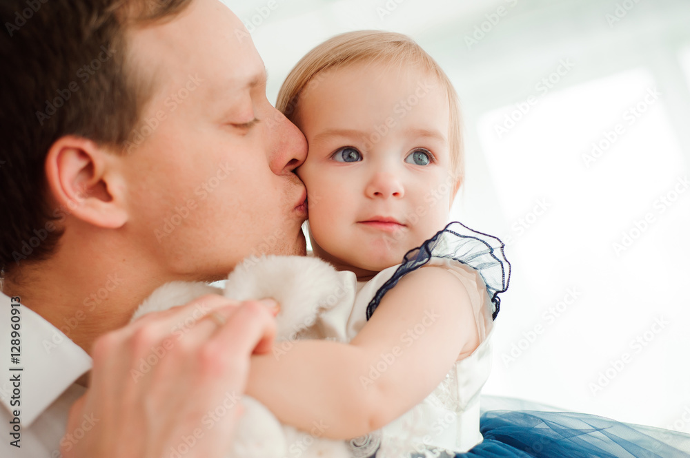 Dad hugging and kissing his little daughter Dad hugging and kissing his little daughter