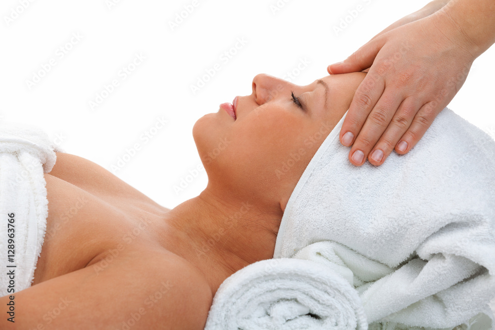 Young woman having a classical massage lying on white bed. Horiz Young woman having a classical massage lying on white bed. Horiz
