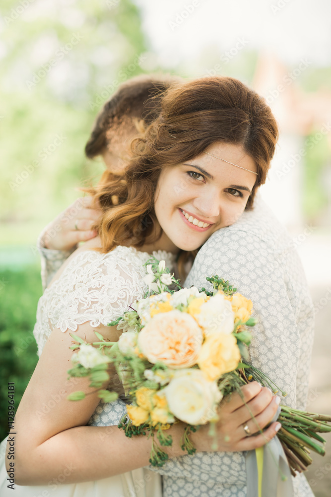 Perfect wedding couple holding luxury bouquet of flowers Perfect wedding couple holding luxury bouquet of flowers