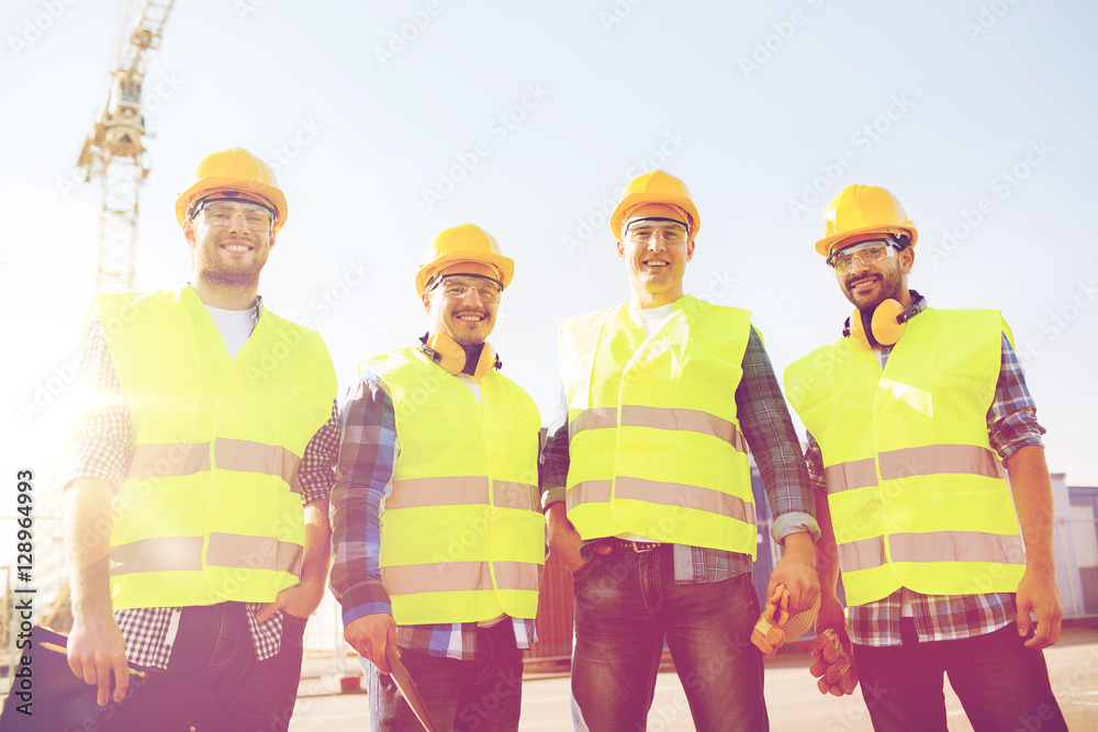 © Syda Productions - group of smiling builders with tablet pc outdoors