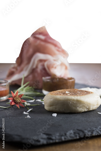 the tigella is a dish very very typical of Emilia, Italy region. It is stuffed with sauces and vegetables and pork cuts photo