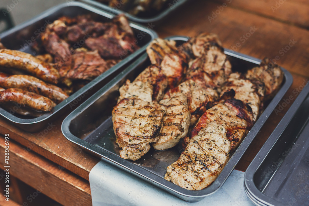 Grill steaks on metal grate, barbecue