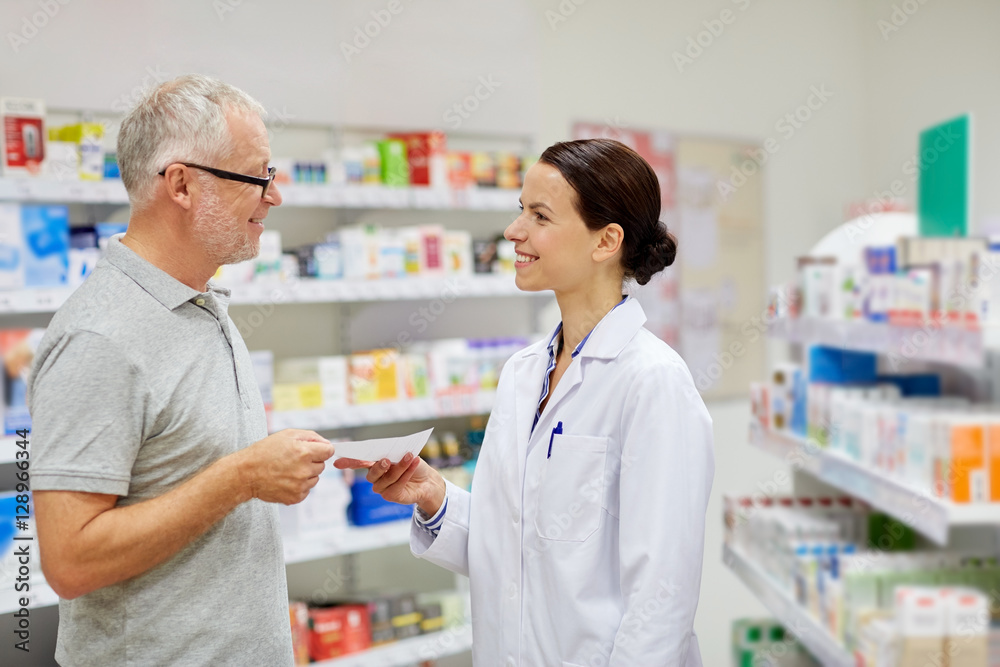 senior man giving prescription to pharmacist senior man giving prescription to pharmacist