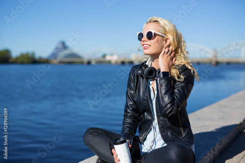 Carefree woman enjoying weather by the water in city setup