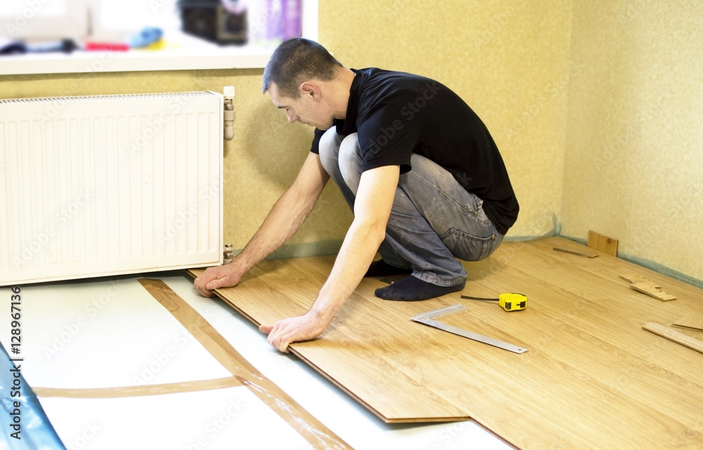 The process of installing laminate wooden on the floor The process of installing laminate wooden on the floor