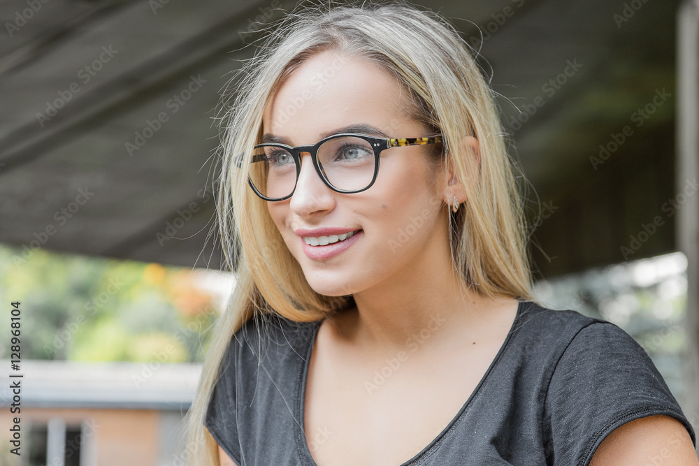 portrait of a young woman, blonde, glasses, outdoors in the park portrait of a young woman, blonde, glasses, outdoors in the park