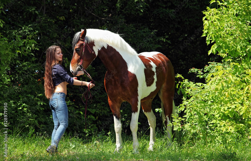 Beautiful stylish girl with a horse walking in the summer forest, country style
Beautiful stylish girl with a horse walking in the summer forest, country style