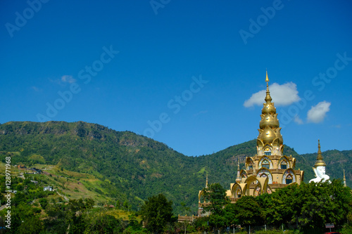 Big White Buddha Statue with mountain and blue sky background at Wat Phasornkaew in Thailand. Photo taken on  29 November   2016