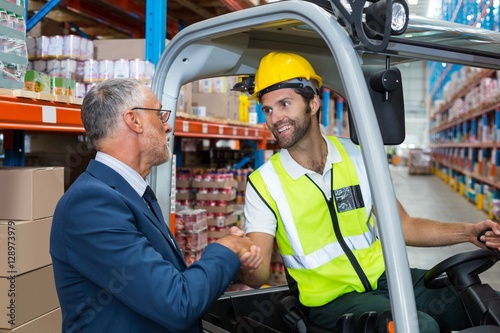 Fotografija Warehouse worker shaking hands manager