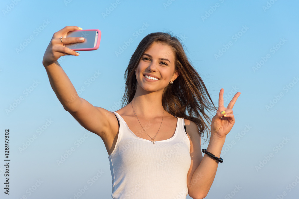 Brunette woman on summer vacation trip taking selfie photo with Brunette woman on summer vacation trip taking selfie photo with