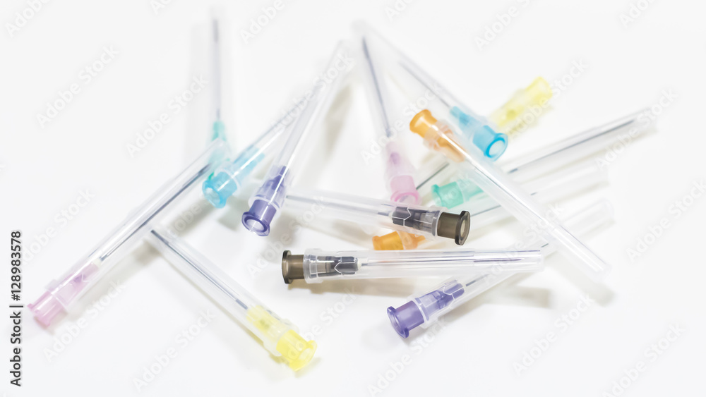 Colorful Needles put in needle sheath on white background.