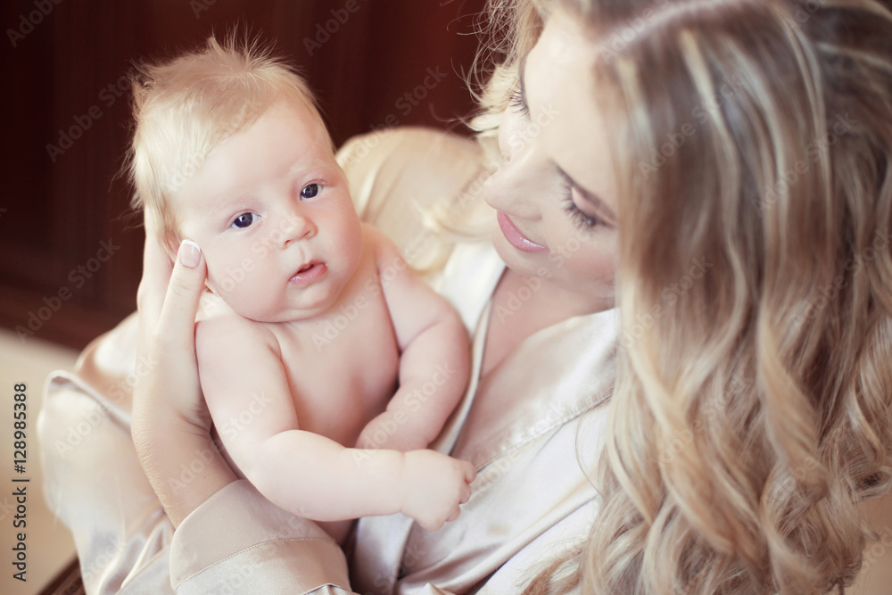 Adorable baby portrait. Happy beautiful mother holding her newbo Adorable baby portrait. Happy beautiful mother holding her newbo