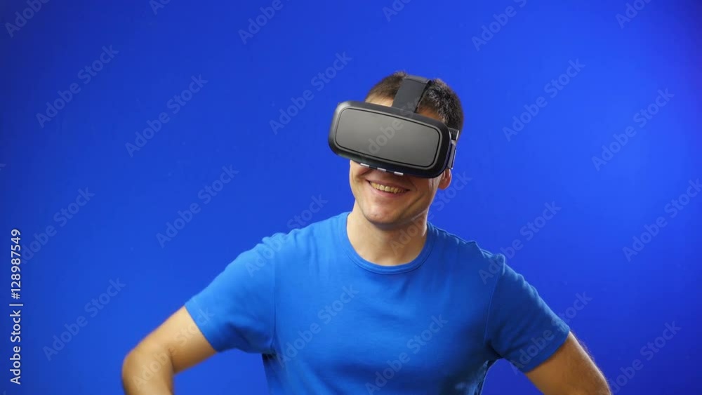 Man in a virtual reality mask observing digital video game world.
Man in a virtual reality mask observing digital video game world.