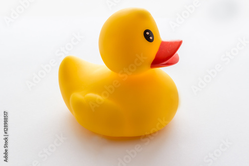 Yellow rubber ducklings on a white background