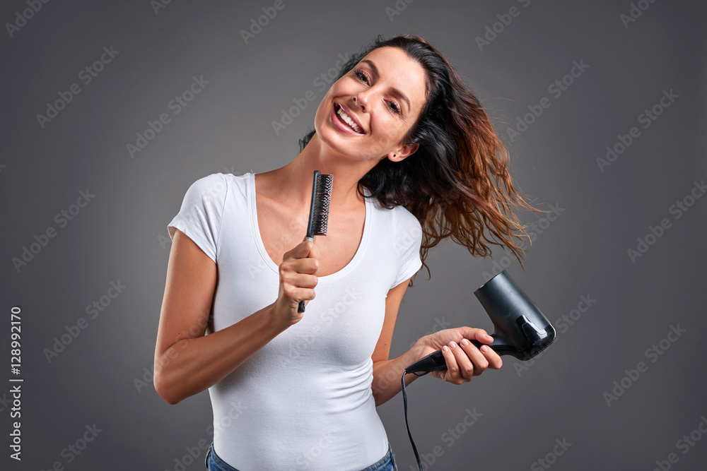 Young woman with a hairdryer Young woman with a hairdryer