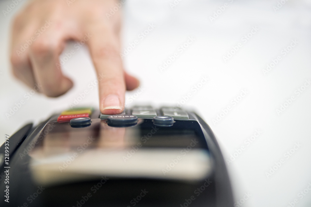 Close-up of cards servicing with POS-terminal, isolated on white background