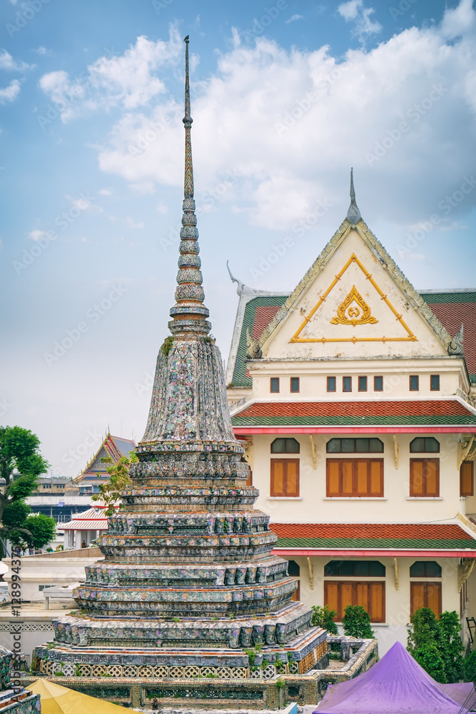 Stupa-like pagoda encrusted with coloured faience in Temple of Dawn, Wat Arun, Bangkok, Thailand.