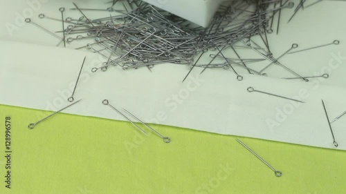 Tailor Puts Dressmaker Pins Into the Box, Which Were Scattered on a Beige Fabric 1.