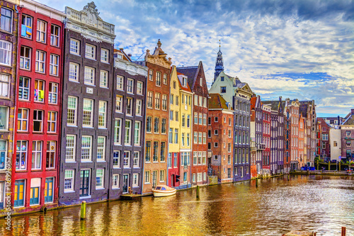 Buildings on the water in Amsterdam and cloudy skies, HDR Image.