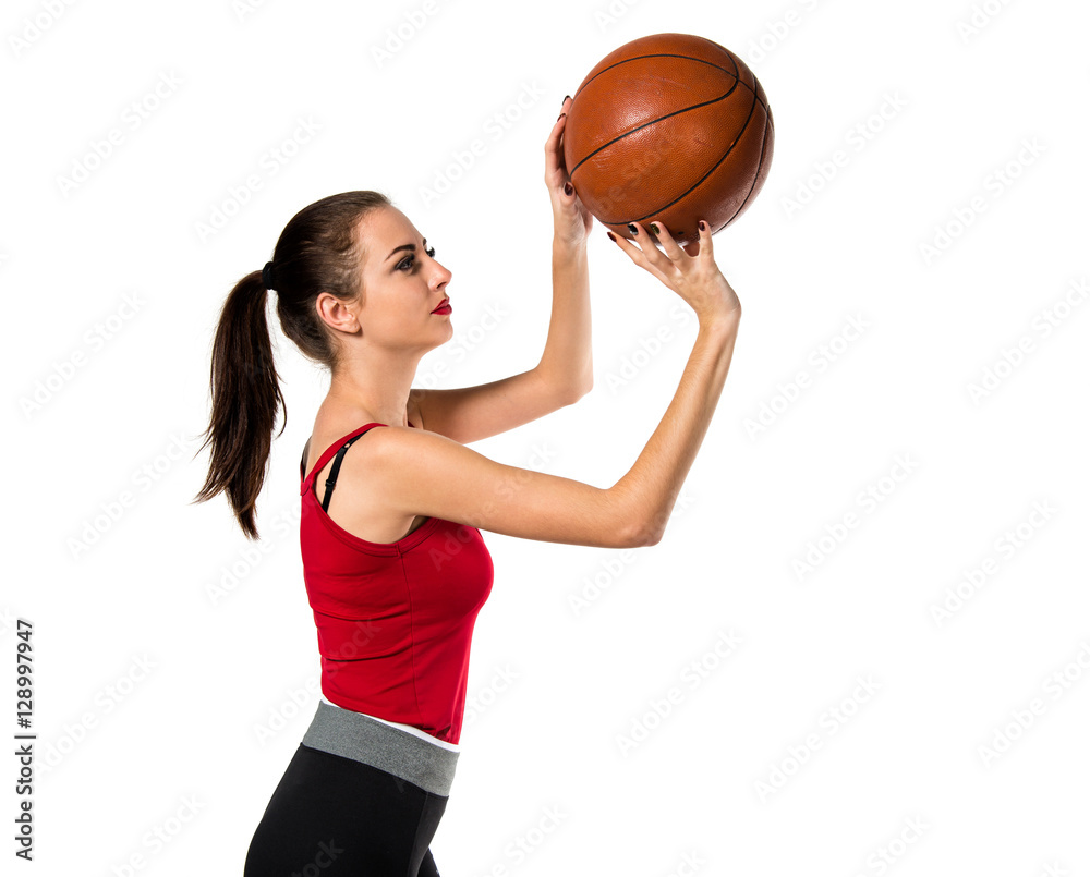 Pretty sport woman playing basketball