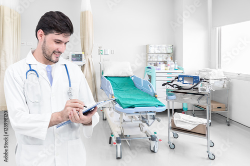 Doctor writing medical records in modern hospital room with beds and comfortable medical equipped