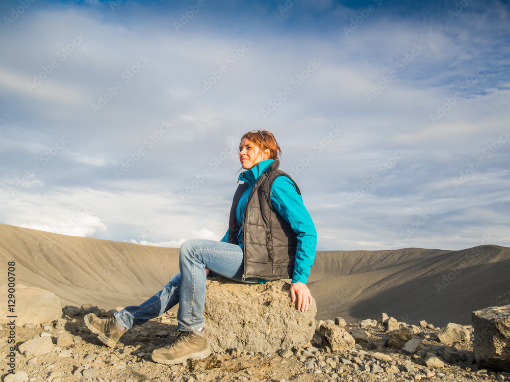 Woman in front of an empty volcanic crater in Iceland