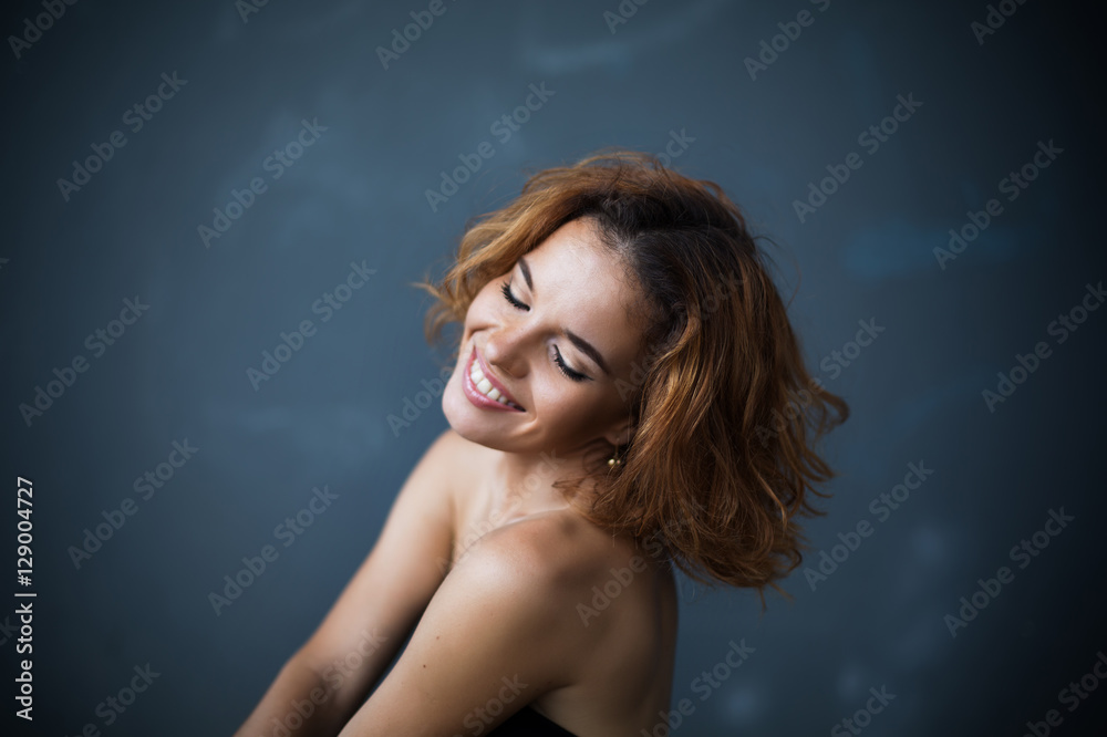 Studio portrait of happy laughing attractive woman with hairstyle Studio portrait of happy laughing attractive woman with hairstyle