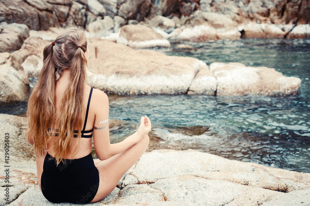 Sport woman doing yoga meditation and relax outside on beach. Fit female sport model girl outdoors Sport woman doing yoga meditation and relax outside on beach. Fit female sport model girl outdoors