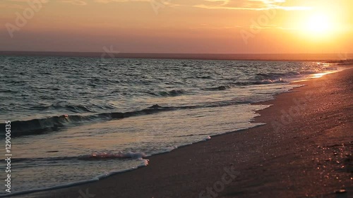 Wallpaper Mural Waves gently wash up onto the beach, then recede as the sun starts to rise.  Torontodigital.ca
