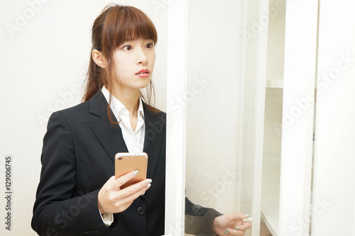 Business woman using smart phone at office