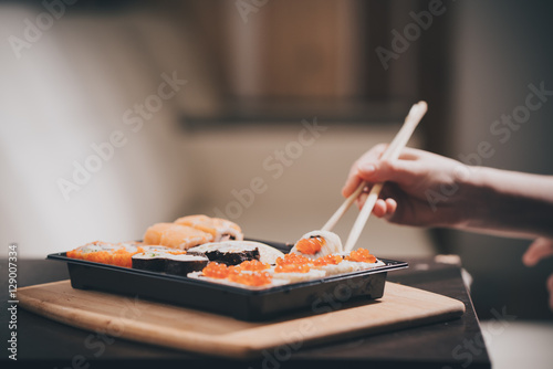 Set sushi set. Hand with chopsticks for sushi. 