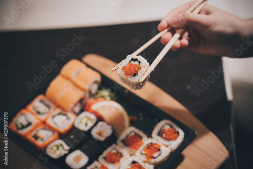 Set sushi set. Hand with chopsticks for sushi. 