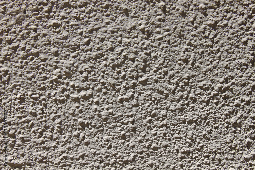 Rough gray wall, illuminated by the sun Rough gray wall, illuminated by the sun