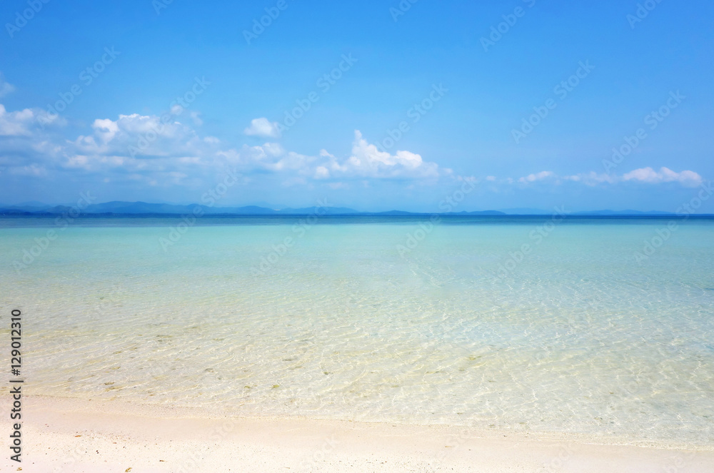 White clouds on blue sky over calm sea. Clear blue sky with fantastic white sand beach with calm ocean, Summer outdoor nature holiday serenity. Talu Island, Prachuap Khiri Khan, Thailand. White clouds on blue sky over calm sea. Clear blue sky with fantastic white sand beach with calm ocean, Summer outdoor nature holiday serenity. Talu Island, Prachuap Khiri Khan, Thailand.