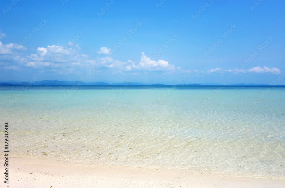 White clouds on blue sky over calm sea. Clear blue sky with fantastic white sand beach with calm ocean, Summer outdoor nature holiday serenity. Talu Island, Prachuap Khiri Khan, Thailand.