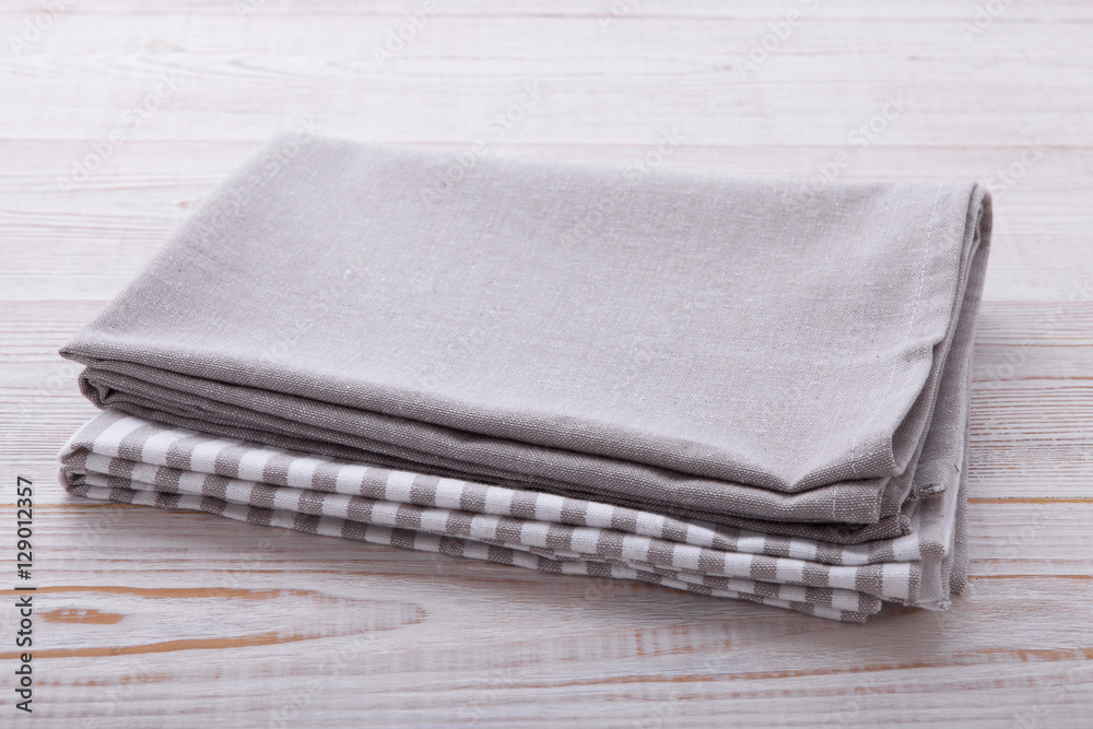 Napkin tablecloth on white wooden table. Empty napkin template. Unique perspectives horizontal. Napkin tablecloth on white wooden table. Empty napkin template. Unique perspectives horizontal.