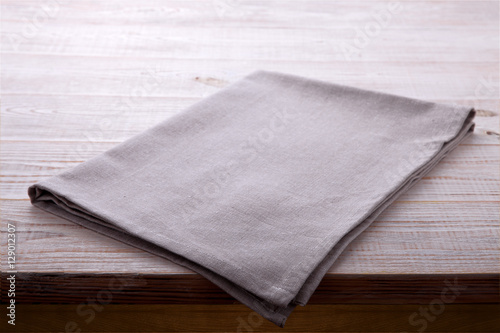 Napkin tablecloth on white wooden table. Empty napkin template. Unique perspectives horizontal.
